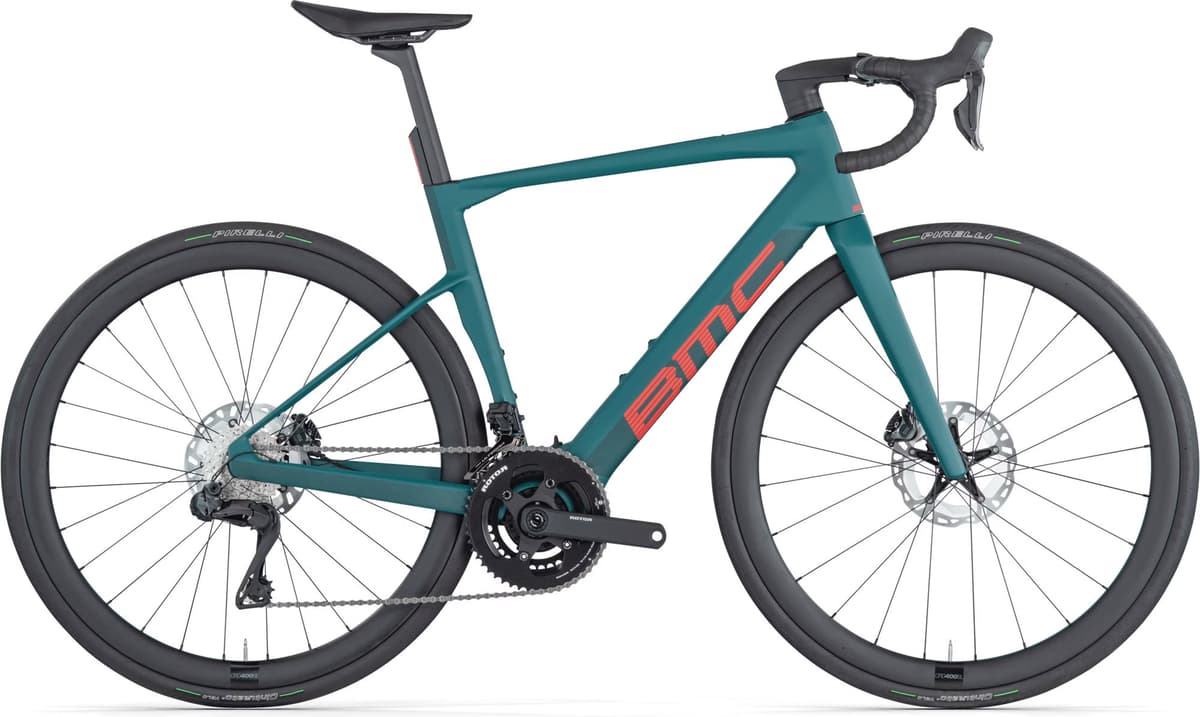 Teal BMC Roadmachine 01 AMP electric road bike with black wheels and red branding.