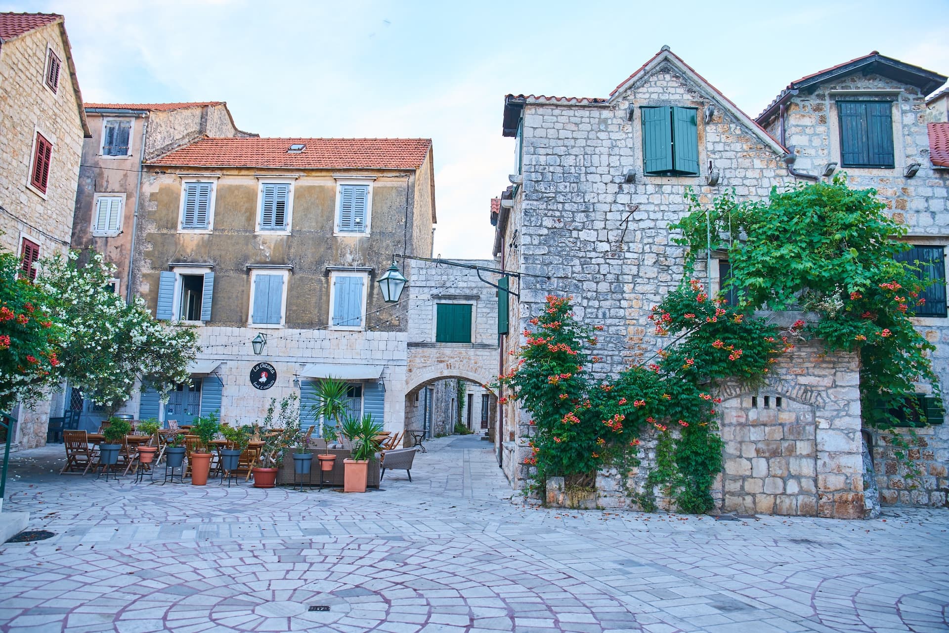 Stone buildings with cafe seating in a paved square in Stari Grad, Hvar.