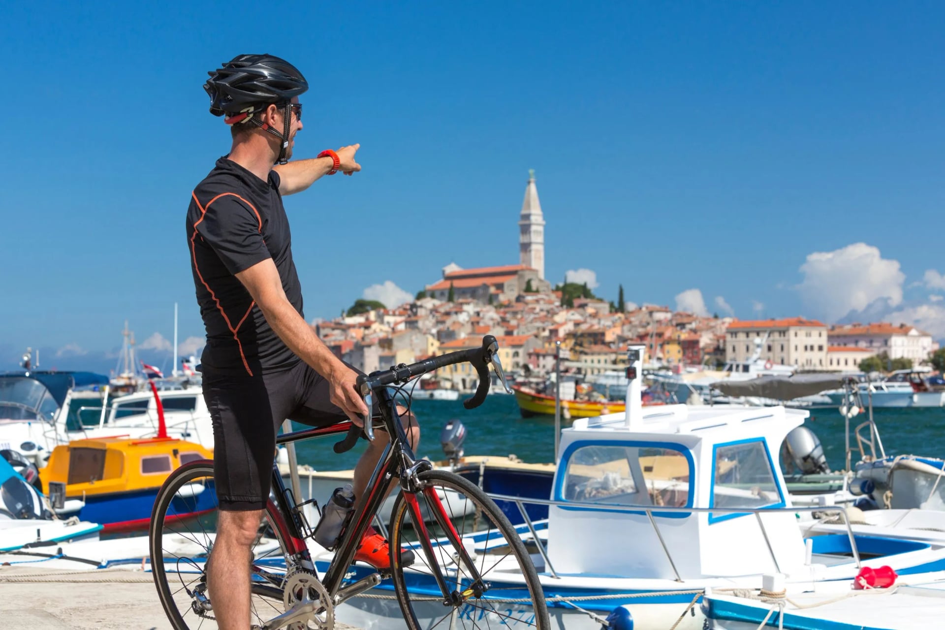 Croatia, Istria, Rovinj, portrait of male cyclist against cityscape