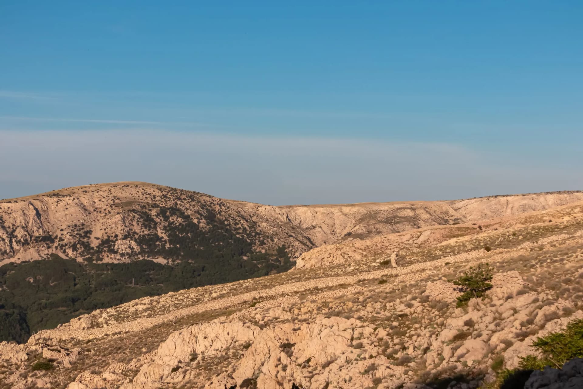 Panoramic view of dry stone walls mrgari on moon plateau seen from mountain top Hlam in Baska, Krk Island, Primorje-Gorski Kotar, Croatia, Europe. Hiking trail on barren deserted dry terrain. Ruins