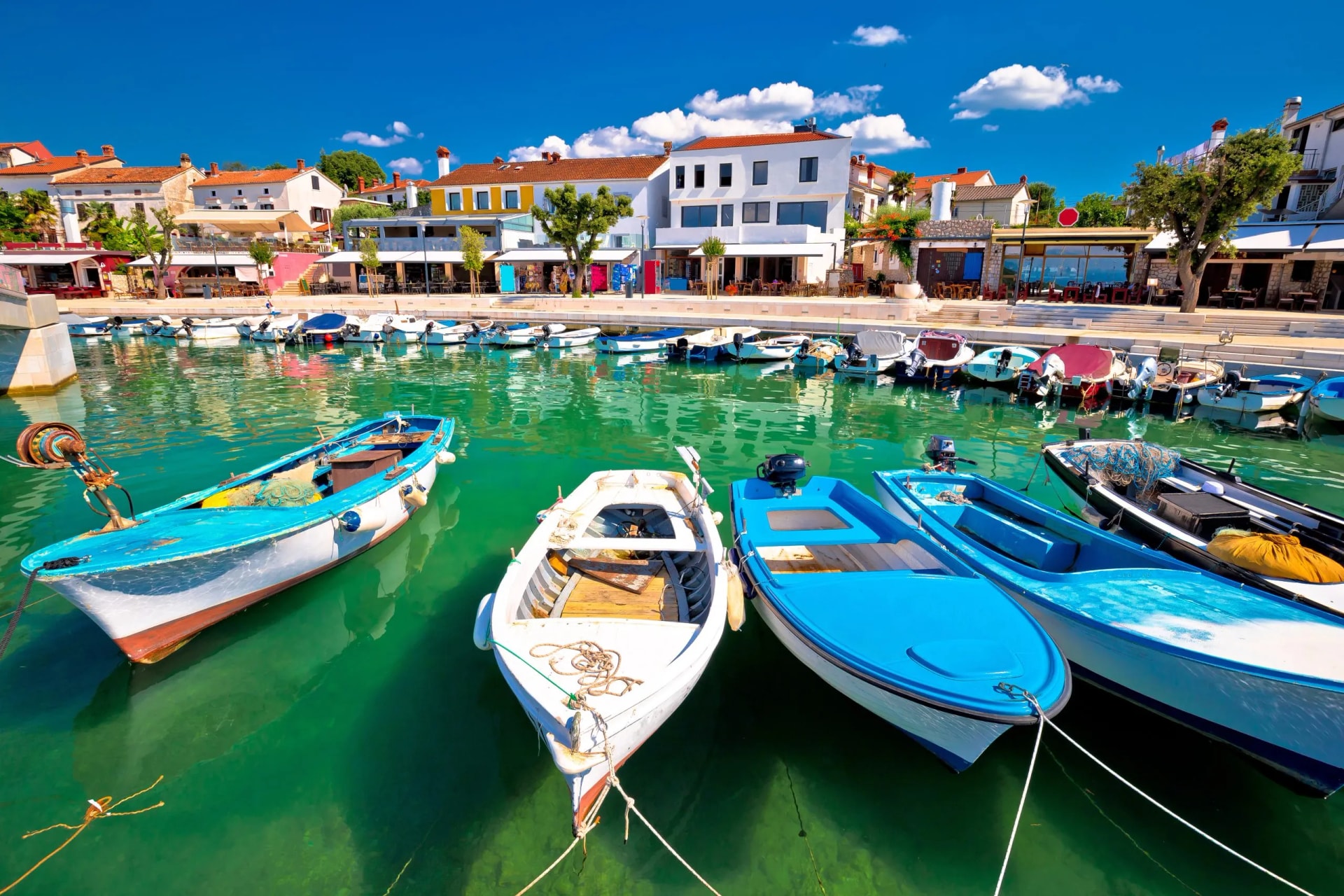 Town of Njivice turquoise harbor and waterfront view