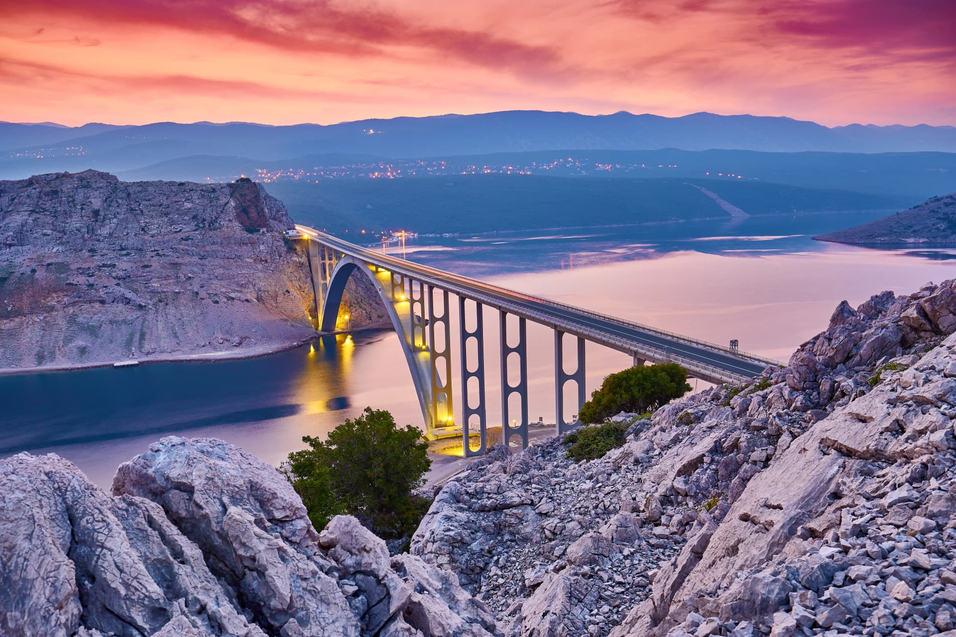 Dramatic summer seascape of Adriatic sea. Bigger arch Bridge to Krk Island at sunrise, near Maslenica, Croatia, Europe. Bridge connects the Croatian island of Krk with the mainland. Morning light.