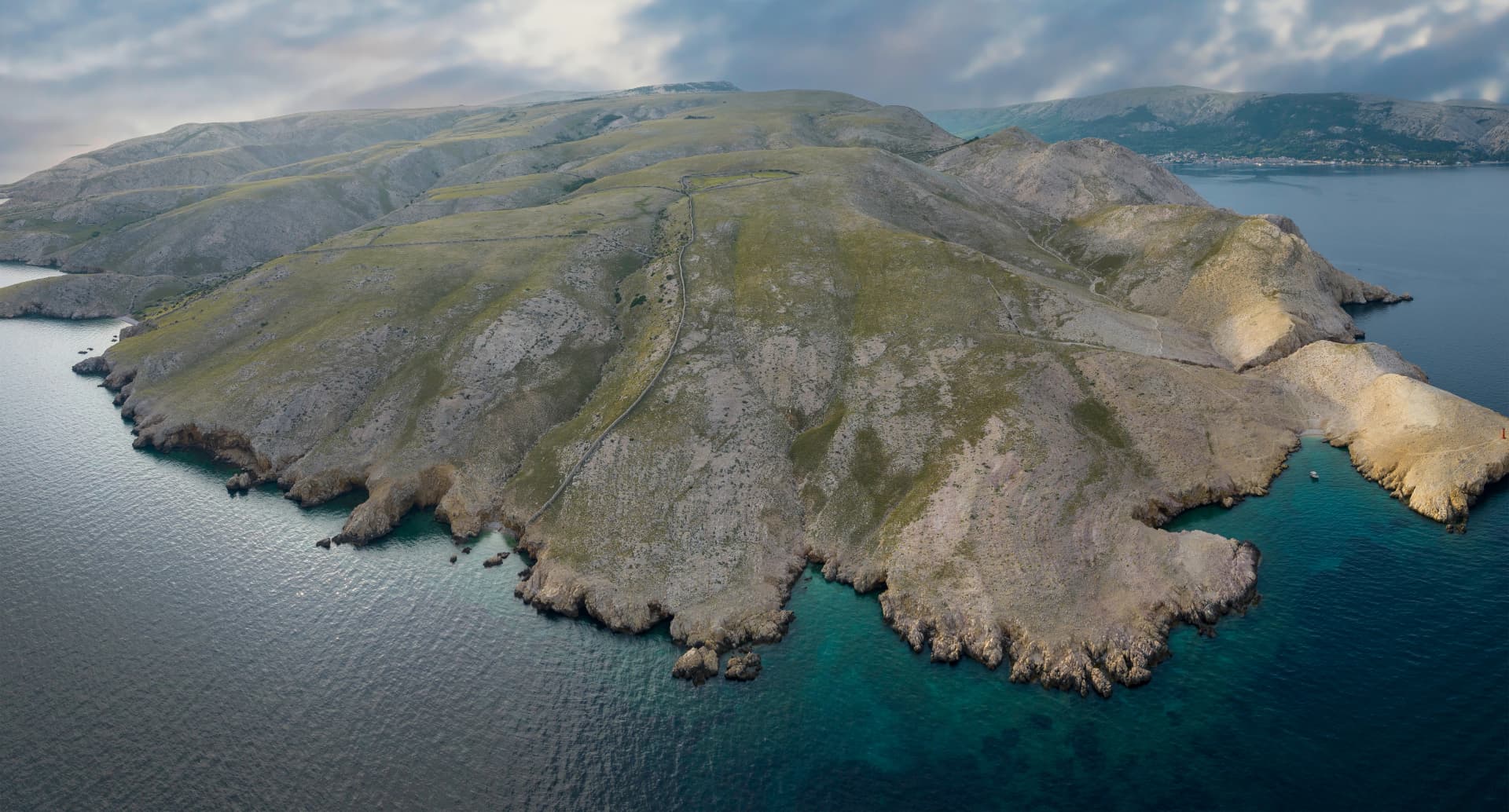 The extreme southwest coast of island Krk with town Baska in the background, Croatia