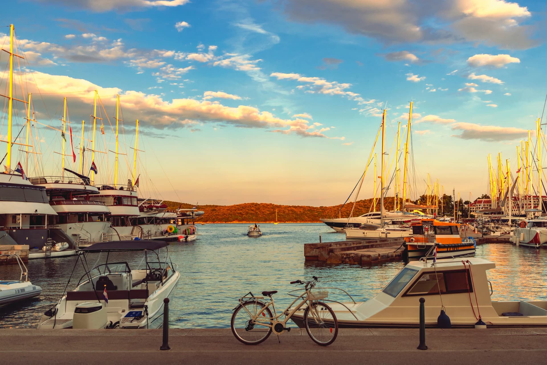 Beautiful viiew of marina with boats and bicycle at sunset, Korcula, Croatia