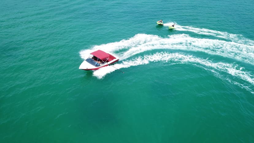 Aerial drone photo of extreme powerboat donut watersports crusing in high speed in tropical turquoise bay