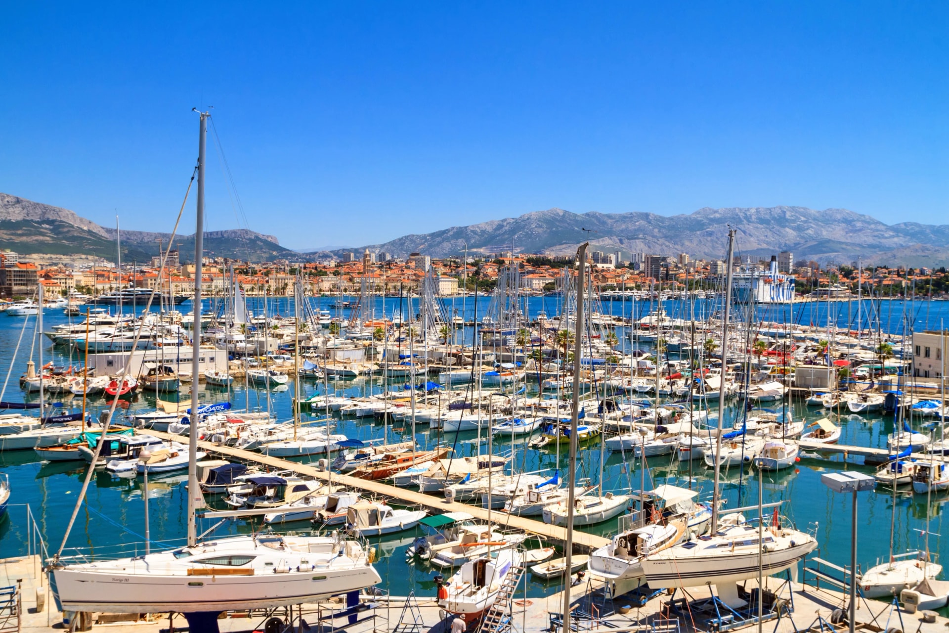Coastal summer cityscape - view of the marina of Split with yachts moored, the Adriatic coast of Croatia