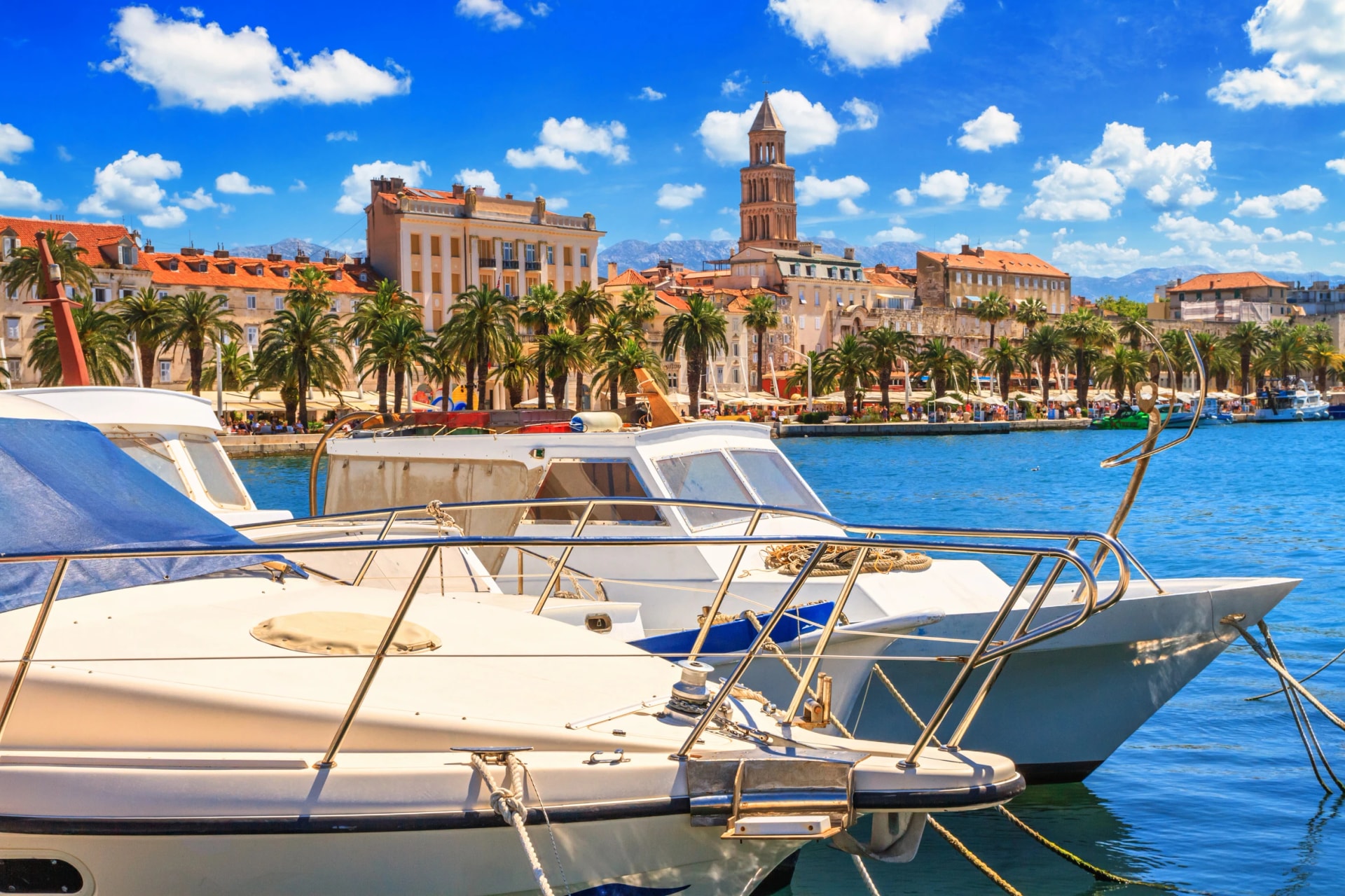 Coastal summer cityscape - view of the embankment the Old Town of Split through moored boats to the pier, the Adriatic coast of Croatia