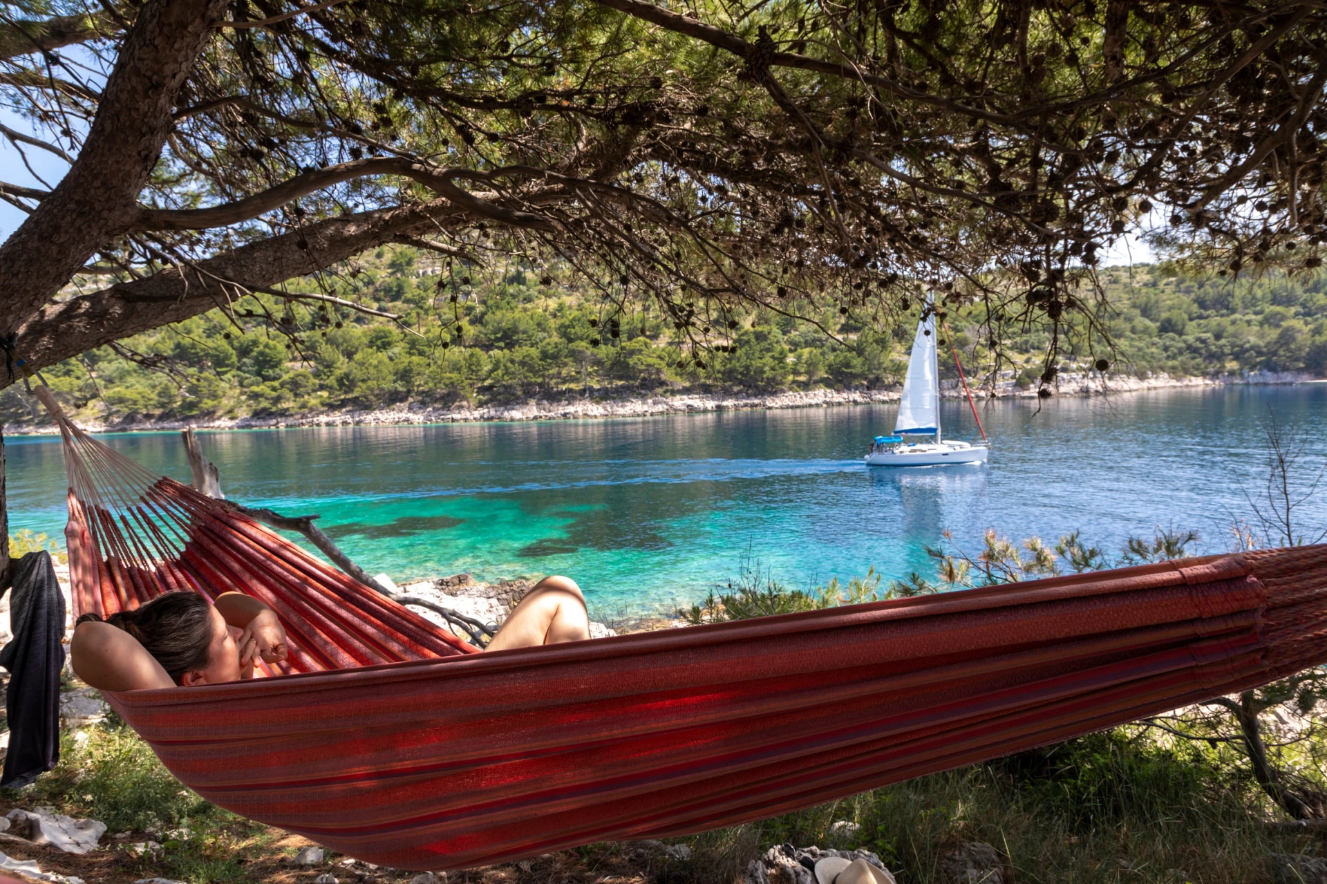 Woman relaxing in the hammock on a hot sunny day on the island lastovo, croatia