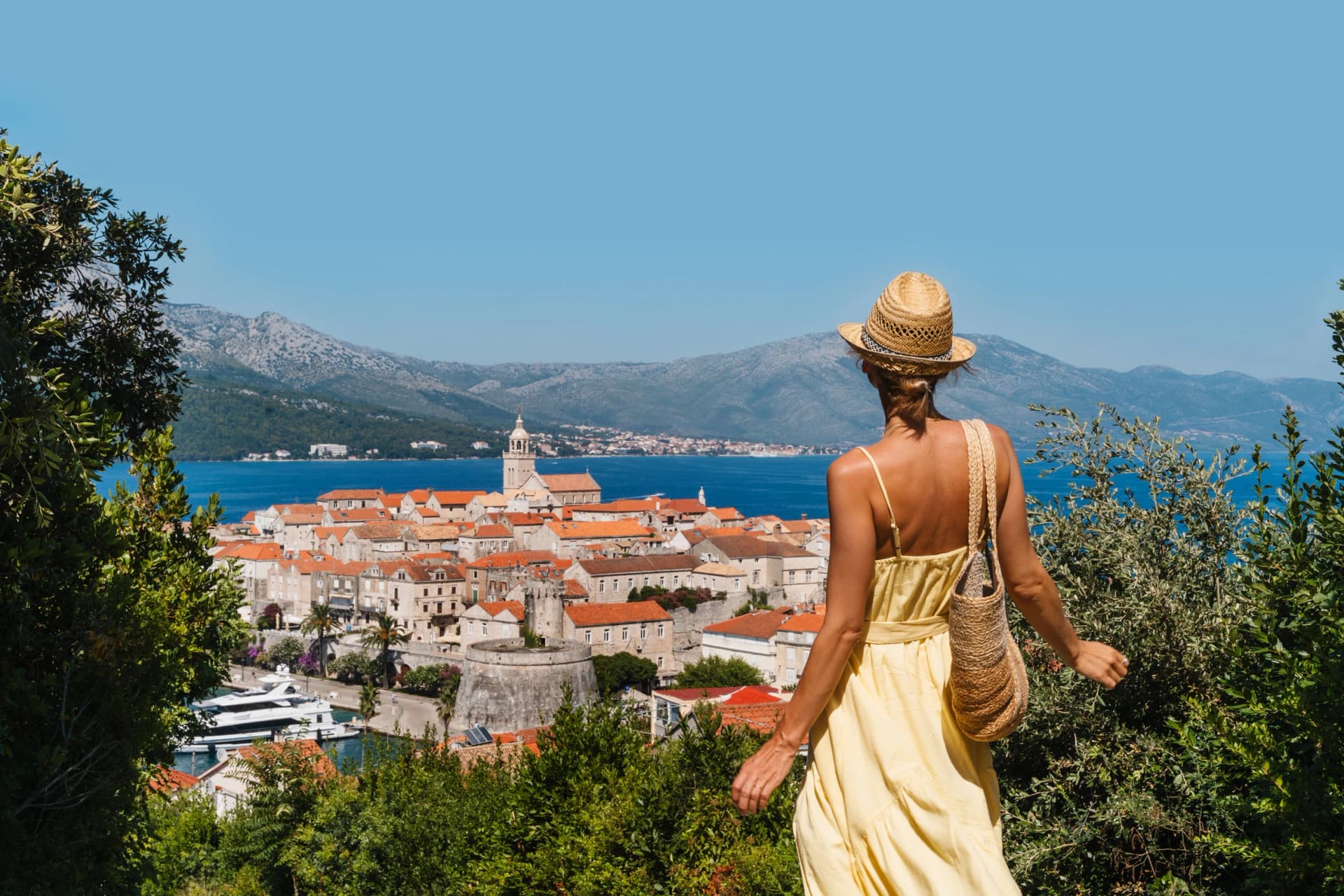 Female tourist enjoying summer vacation in Croatia, Korcula Island, Korcula Town.